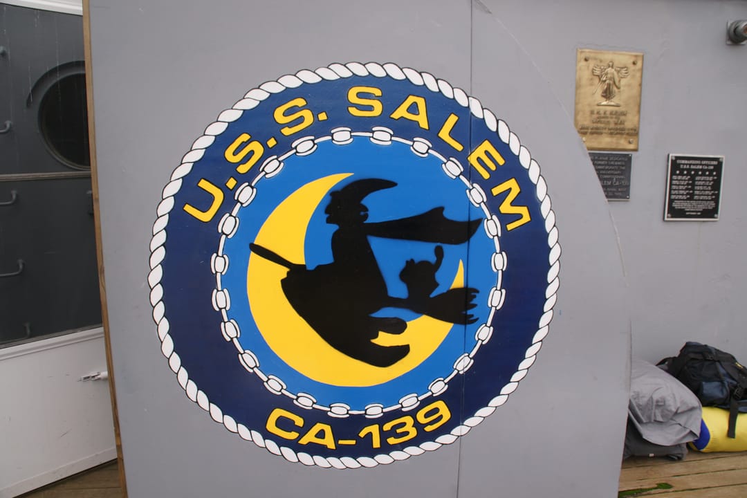 USS Salem's ship's seal mounted aboard, reading 'U.S.S. SALEM CA-139.'