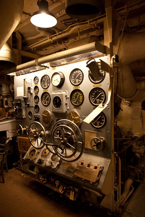 An engine-order/thrust control panel with its bank of gauges, preserved aboard USS Salem.