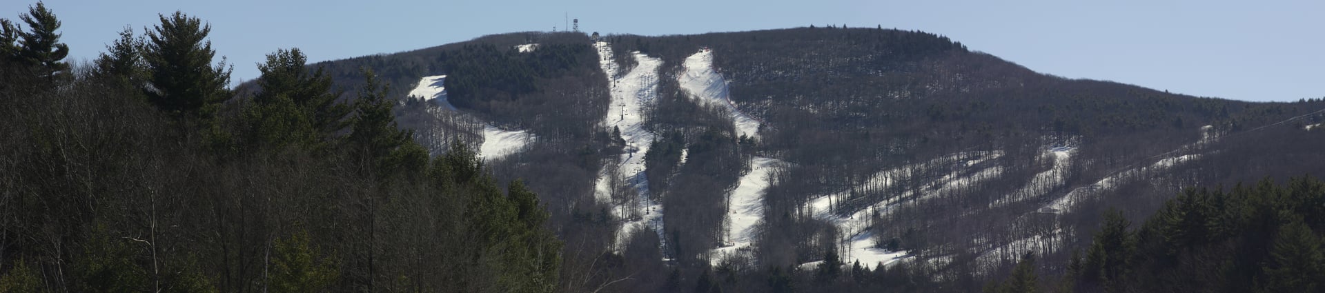 Wachusett Mountain rising in winter behind the main gate of the ski area in Princeton, central Massachusetts.