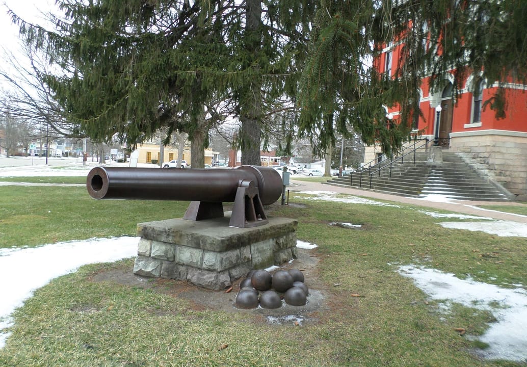 A cannon on the grounds of the former Eaton County Courthouse, now a museum, located at 100 W Lawrence Ave, Charlotte, MI. The building is listed on the National Register of Historic Places.
