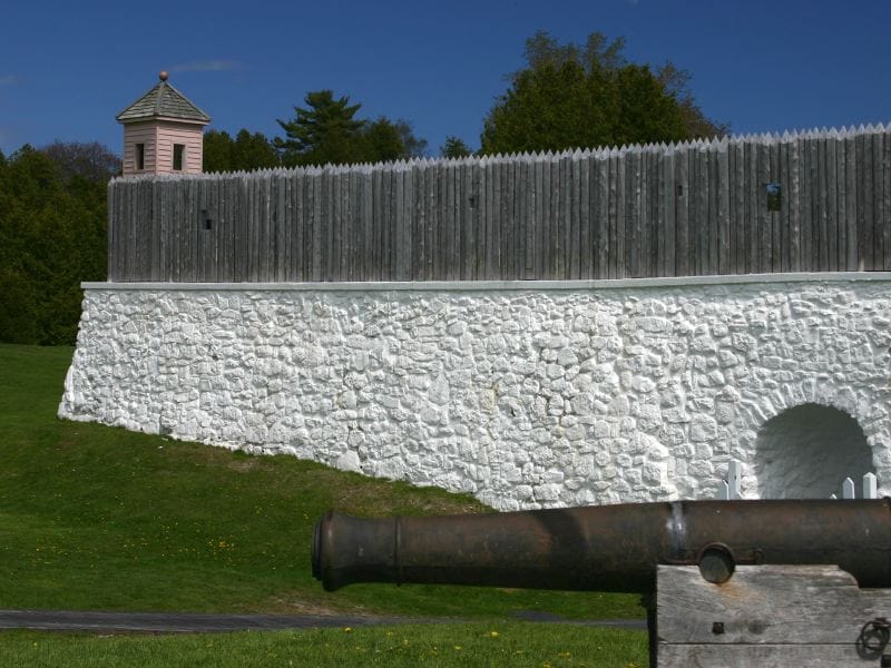 A stone-and-timber rampart with a mounted cannon at Fort Mackinac, Mackinac Island, 2004.