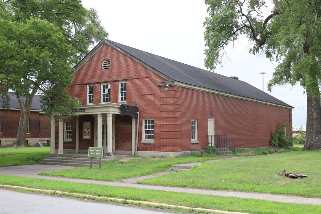 A brick building with a columned entrance portico at Historic Fort Wayne, Detroit.