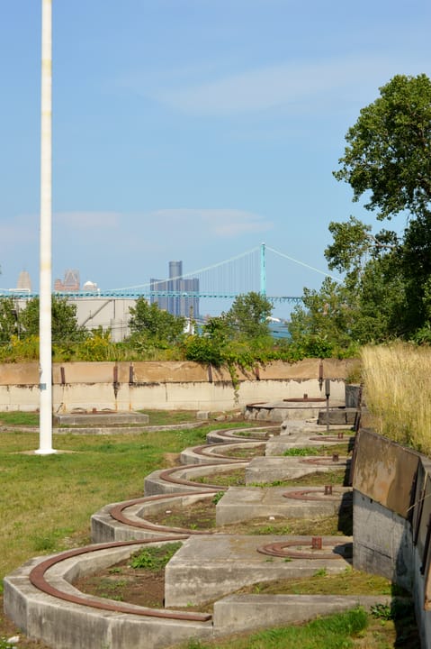 Concrete artillery emplacements at Historic Fort Wayne, with the Detroit skyline visible across the river in the background.