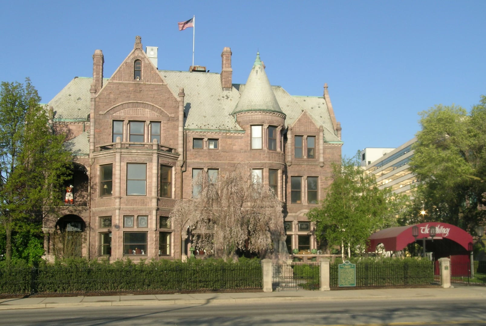 The Whitney mansion exterior at dusk in Detroit, Michigan, a stop on the Motor City Ghosts walking tour