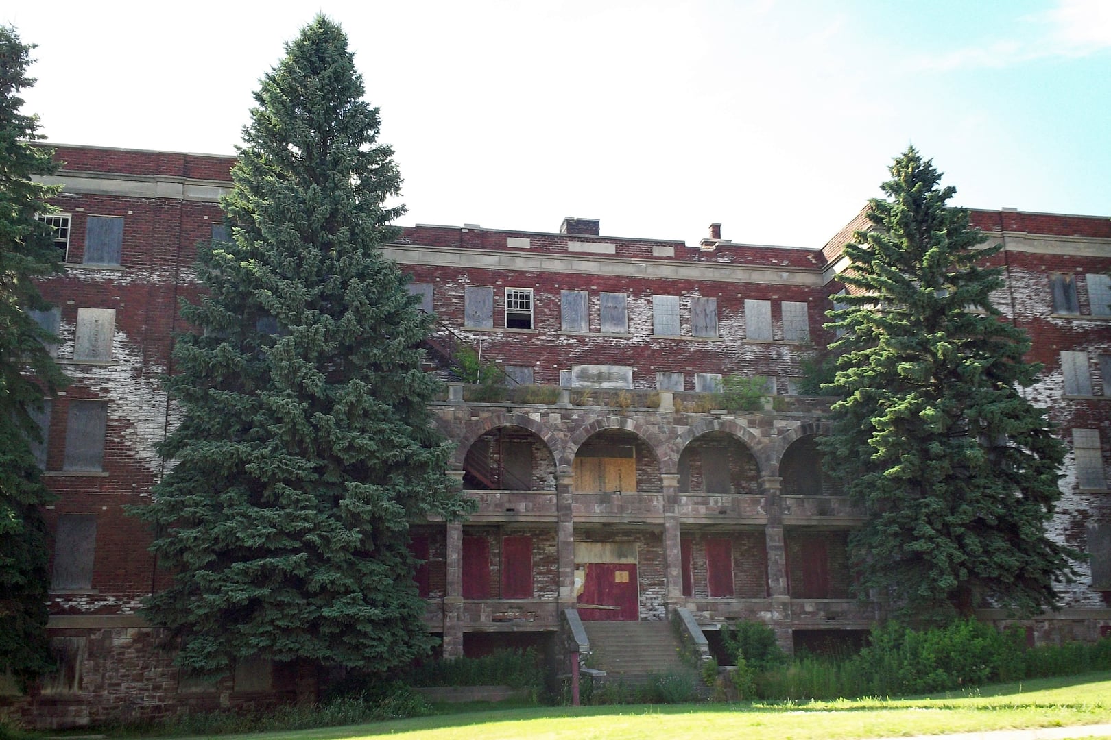 Renaissance Revival brick facade of the abandoned Holy Family Orphanage in Marquette, Michigan, a National Register-listed building constructed in 1915.