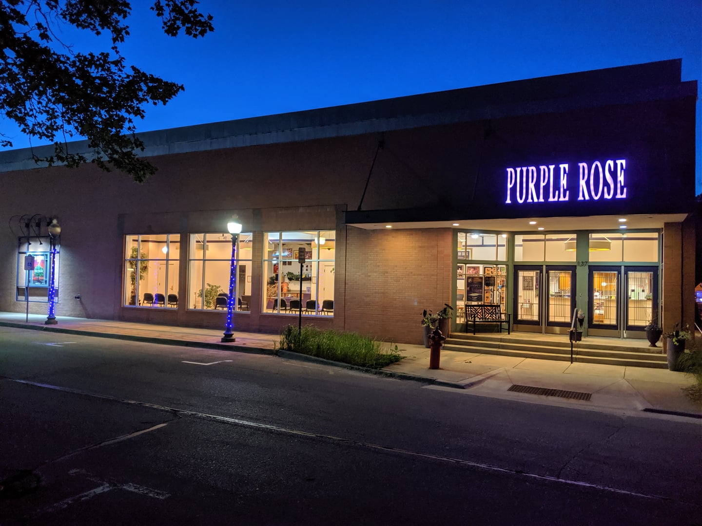 The front of the Purple Rose Theatre on Park Street in Chelsea, Michigan, at dusk