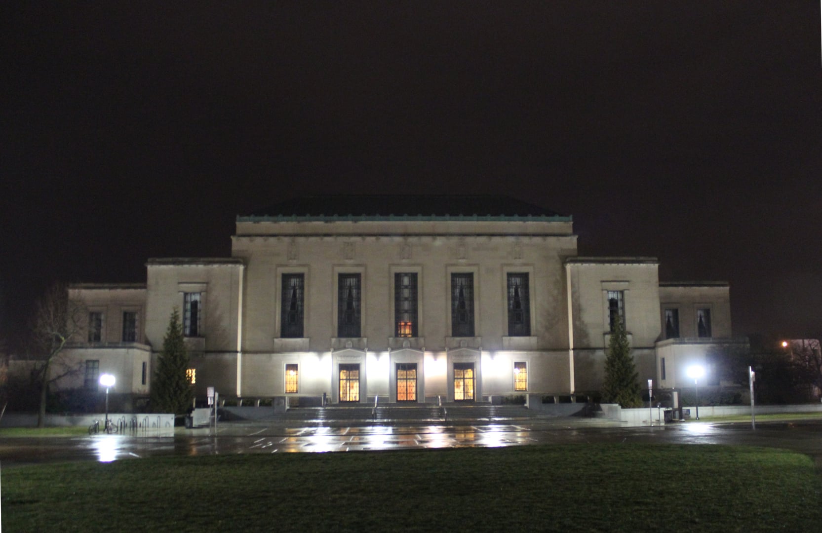 Indiana limestone classical Art Deco exterior of the Horace H. Rackham Graduate School Building, dedicated 1938, illuminated at night on the University of Michigan campus, Ann Arbor
