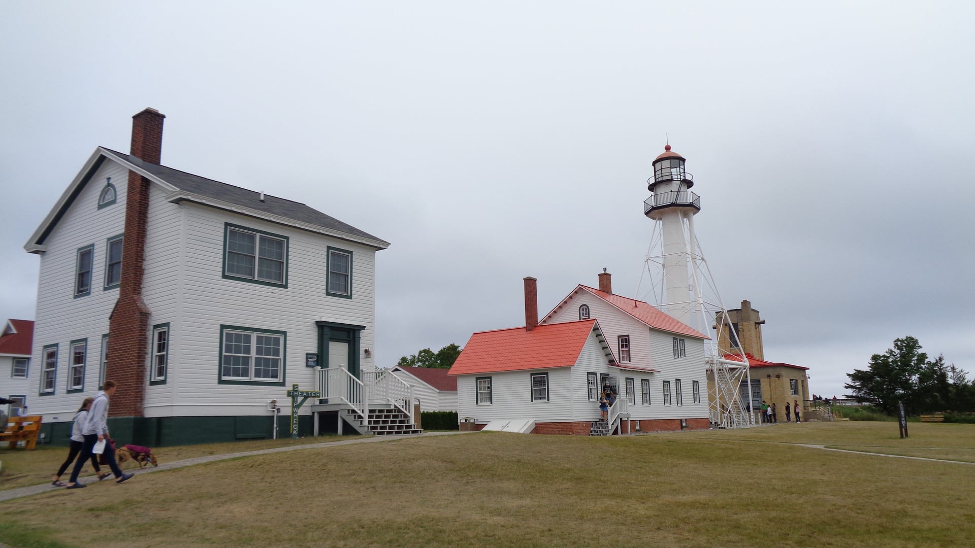 Whitefish Point Light steel skeletal tower beside white keeper's quarters on Lake Superior Michigan