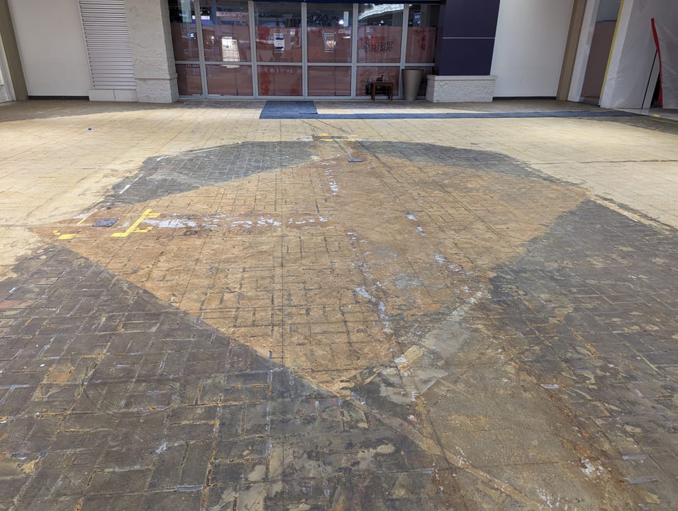 Older brick flooring exposed by removal of carpet.  Former Gordmans at Burnsville Center.