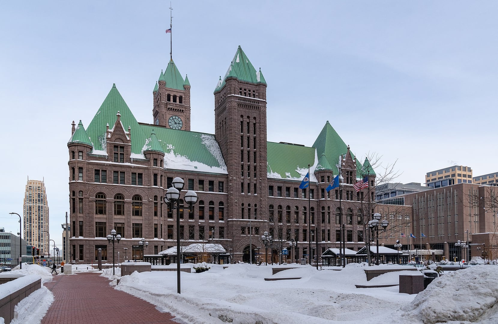 Minneapolis City Hall and Government Plaza in winter, showing the Richardsonian Romanesque rough-cut granite exterior and clock tower in downtown Minneapolis, Minnesota