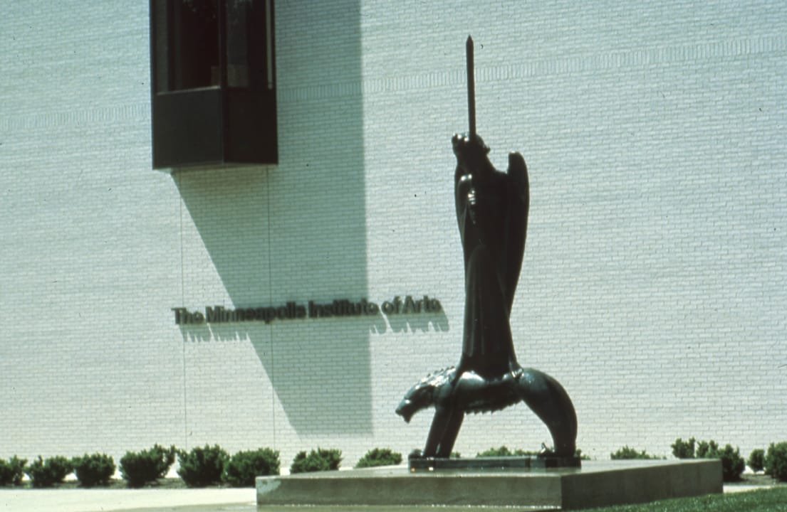 'The Fighter of the Spirit' (1928) by Ernst Barlach outside the Minneapolis Institute of Arts, with the museum's name lettered on the wall behind it, 2015.