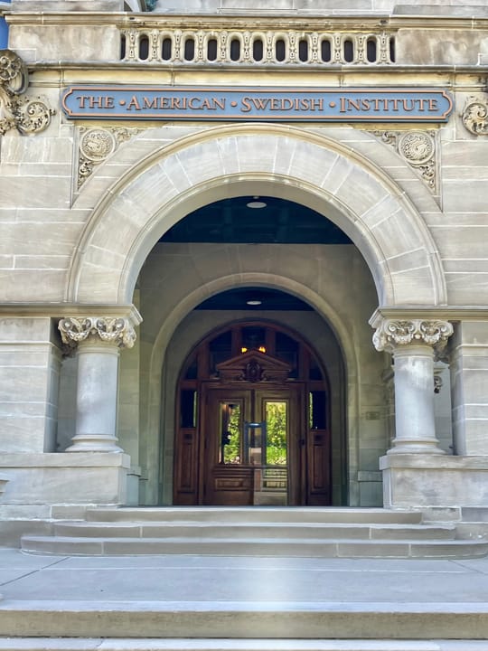 Entrance archway carved with "THE AMERICAN SWEDISH INSTITUTE," the mansion's public museum entrance.