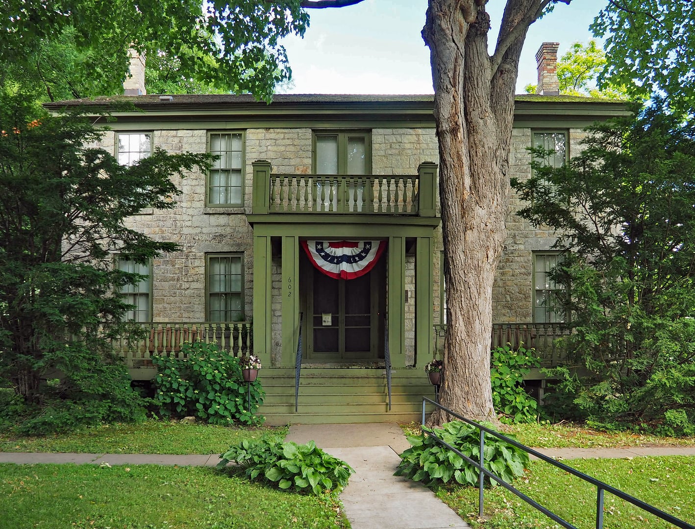 Two-story limestone Warden's House Museum building in Stillwater, Minnesota, viewed from the east