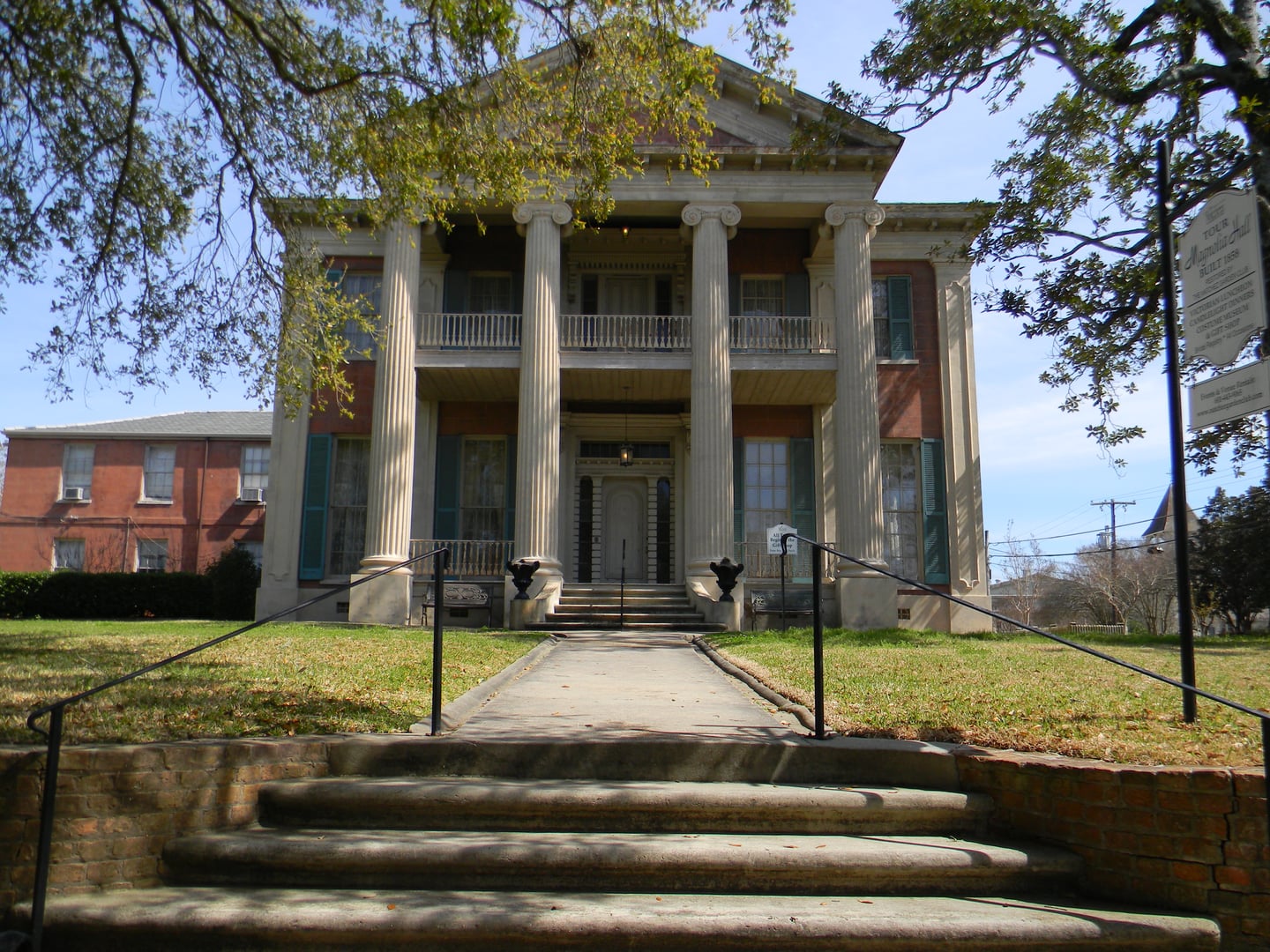 Greek Revival front facade of Magnolia Hall (the 1858 Henderson-Britton House) on Pearl Street in Natchez, Mississippi