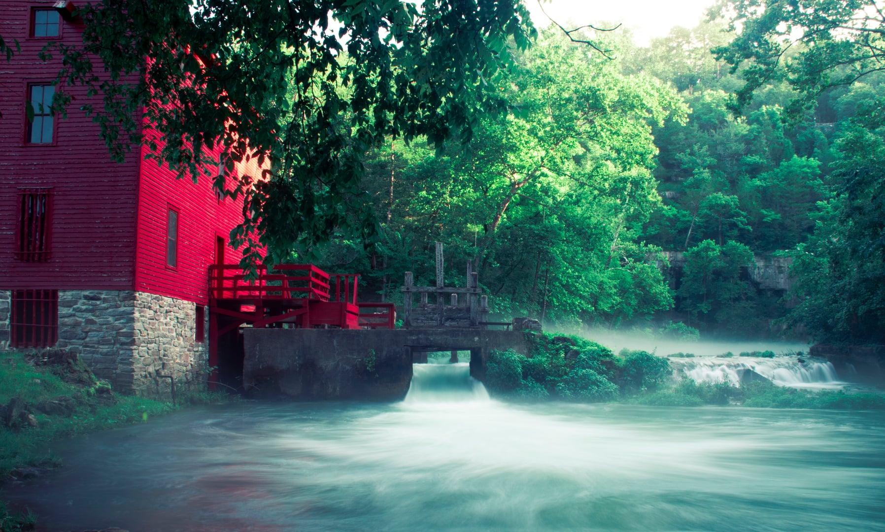 The red Alley Spring Roller Mill beside the spring at Alley Spring, Ozark National Scenic Riverways, near Eminence, Missouri.