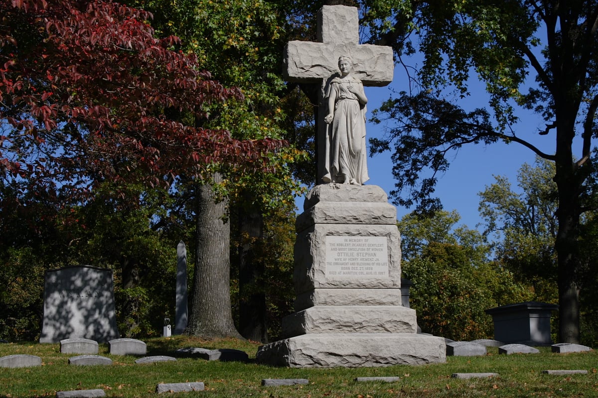 Grave crosses amid autumn foliage at Bellefontaine Cemetery, the 1849 rural cemetery and arboretum in north St. Louis, Missouri