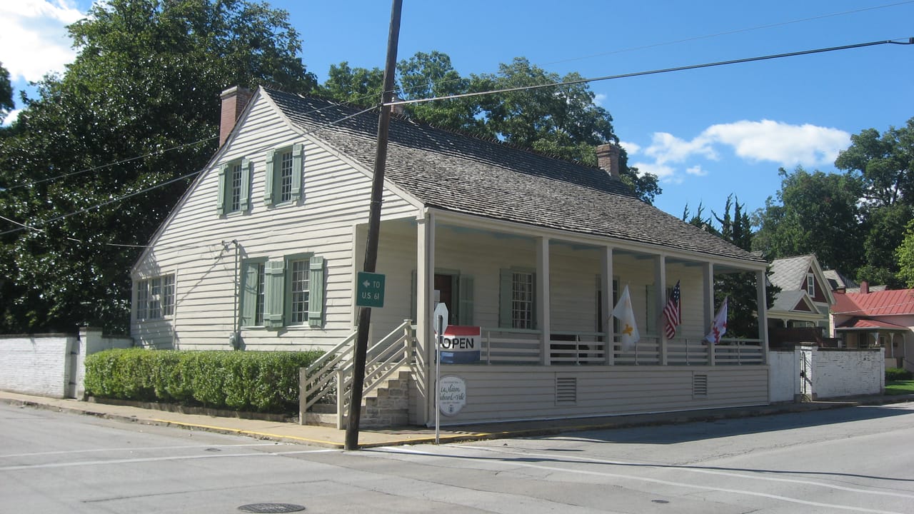 Front and southern side of the Jacques Dubreuil Guibourd House, located on the northwestern corner of the junction of Fourth and Merchant Streets in Ste. Genevieve, Missouri, United States.  Built in 1800, it is listed on the National Register of Historic Places, and it is part of a National Histori