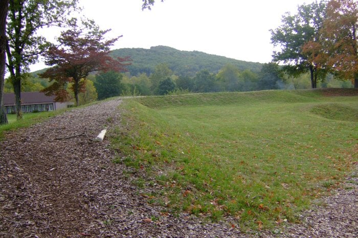 Earthwork remains of Fort Davidson with the powder-magazine crater and Pilot Knob hill in the background, Iron County, Missouri