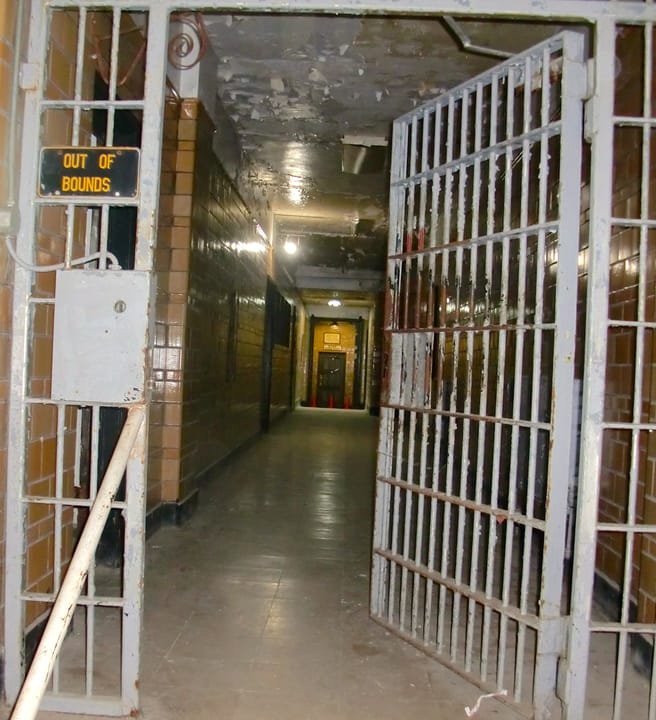An open cell-block gate opening onto a tiled hallway inside the Missouri State Penitentiary museum, Jefferson City, Missouri, 2013.
