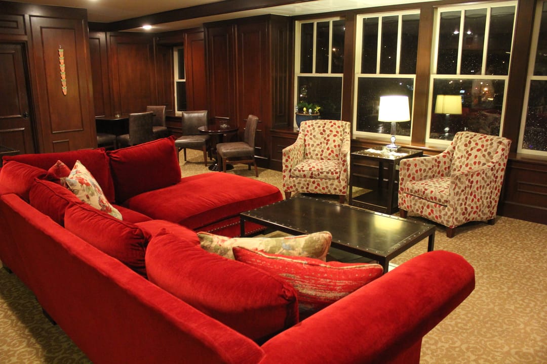 A wood-paneled guest lounge with red upholstered seating on the Elms Hotel's fifth floor, Excelsior Springs, Missouri.