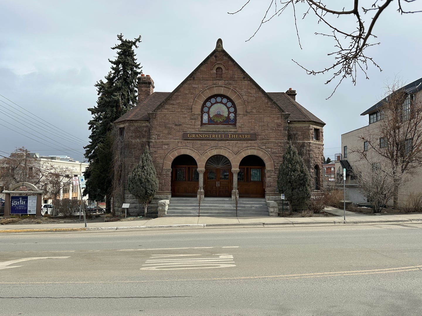 Front view of Grandstreet Theatre, a granite Romanesque building in downtown Helena, Montana