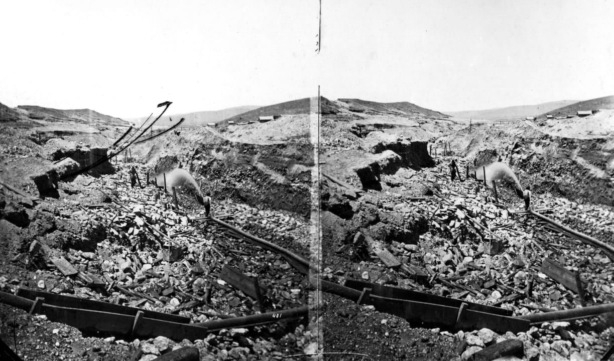 Stereograph of hydraulic placer-mining operations in the gulch near Virginia City in 1871, miners working the gold diggings that founded the town in 1863.