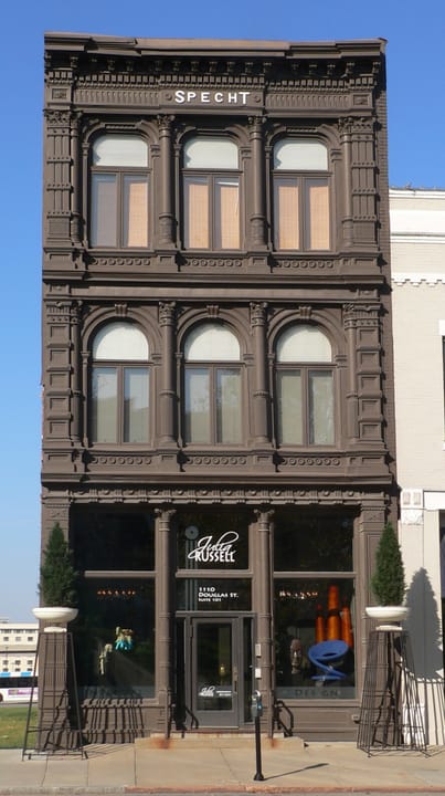 The Christian Specht Building, 1110 Douglas Street, Omaha -- the Museum of Shadows's building since June 2020 -- full three-story Italianate cast-iron-front facade, three-quarter view from the southwest.