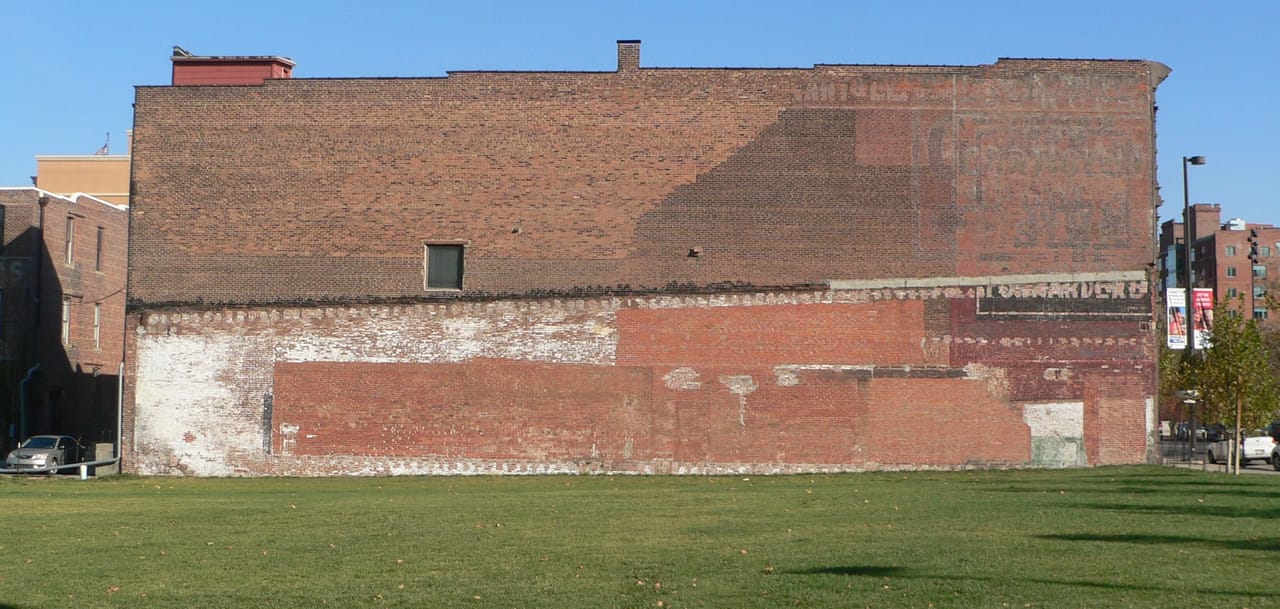 The Christian Specht Building seen from the west, showing the building's full depth and south-facing front turning the corner toward Douglas Street, with the surrounding Old Market block visible.