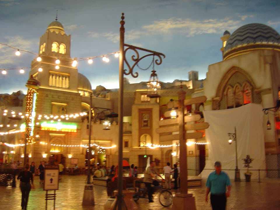 The Desert Passage courtyard inside the Aladdin Hotel, Las Vegas, at dusk, showing its themed archways and string lighting, October 2003.
