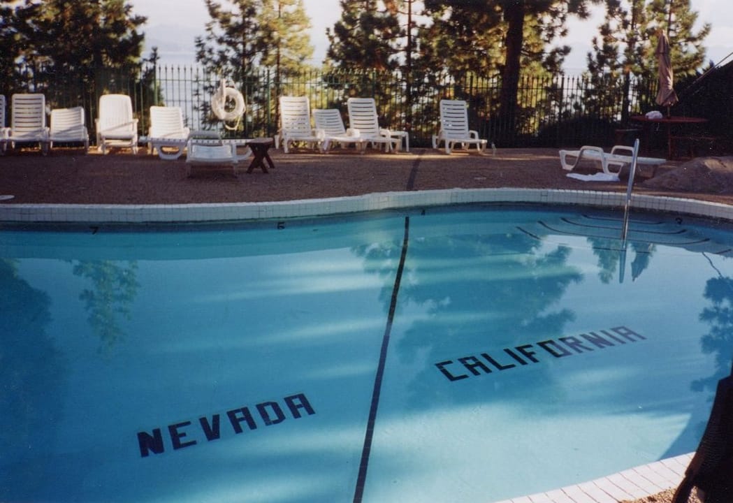 The outdoor swimming pool at the Cal Neva Lodge, with the California-Nevada state line painted across the pool bottom.