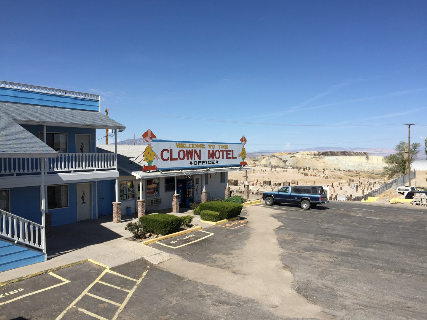 Exterior of the Clown Motel along Main Street in Tonopah, Nevada, with cemetery visible nearby