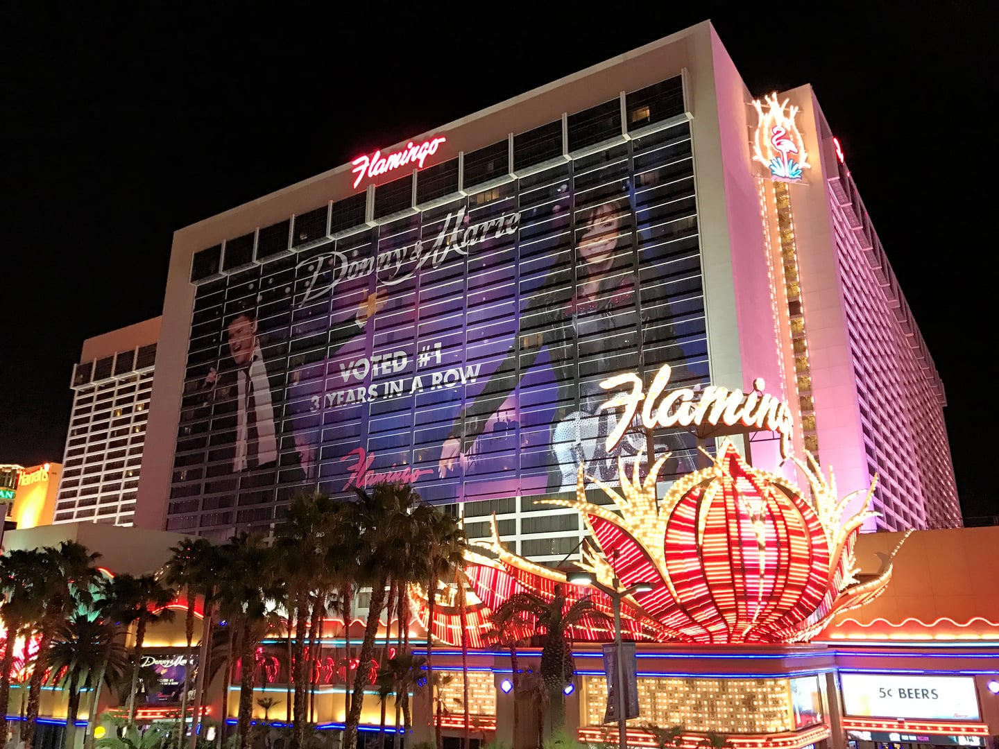 Pink-lit Flamingo Las Vegas Hotel & Casino exterior at night on the Las Vegas Strip