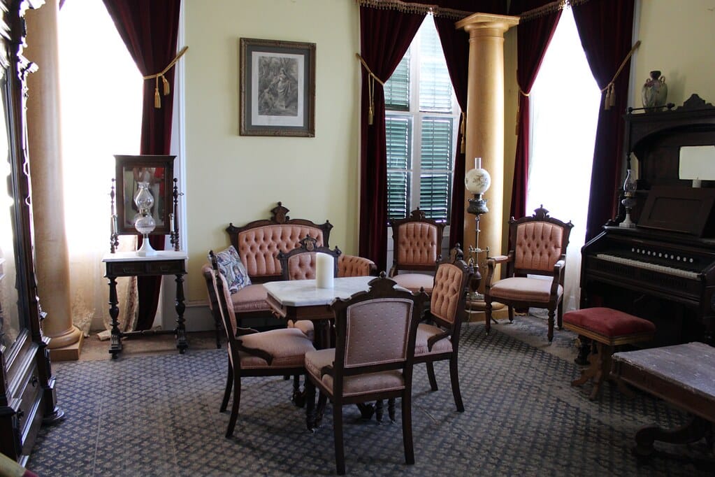 The furnished parlor inside the Mackay Mansion house museum, part of the venue's public walk-through tour.