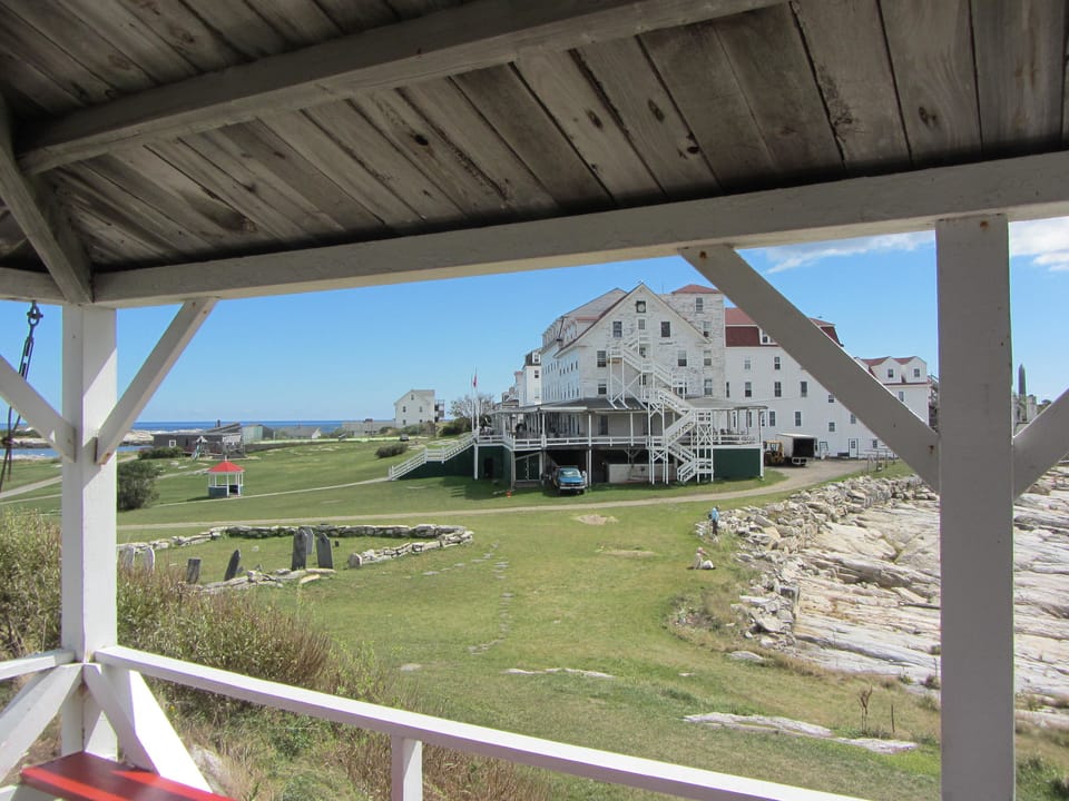 The Oceanic Hotel seen across the lawn and old foundation stones from a neighboring porch on Star Island, Isles of Shoals, New Hampshire.