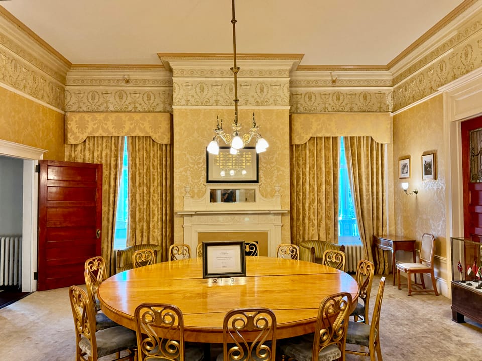 The hotel's conference room with its round wooden table, the type of space associated with the 1944 Bretton Woods Conference named in the venue's history.