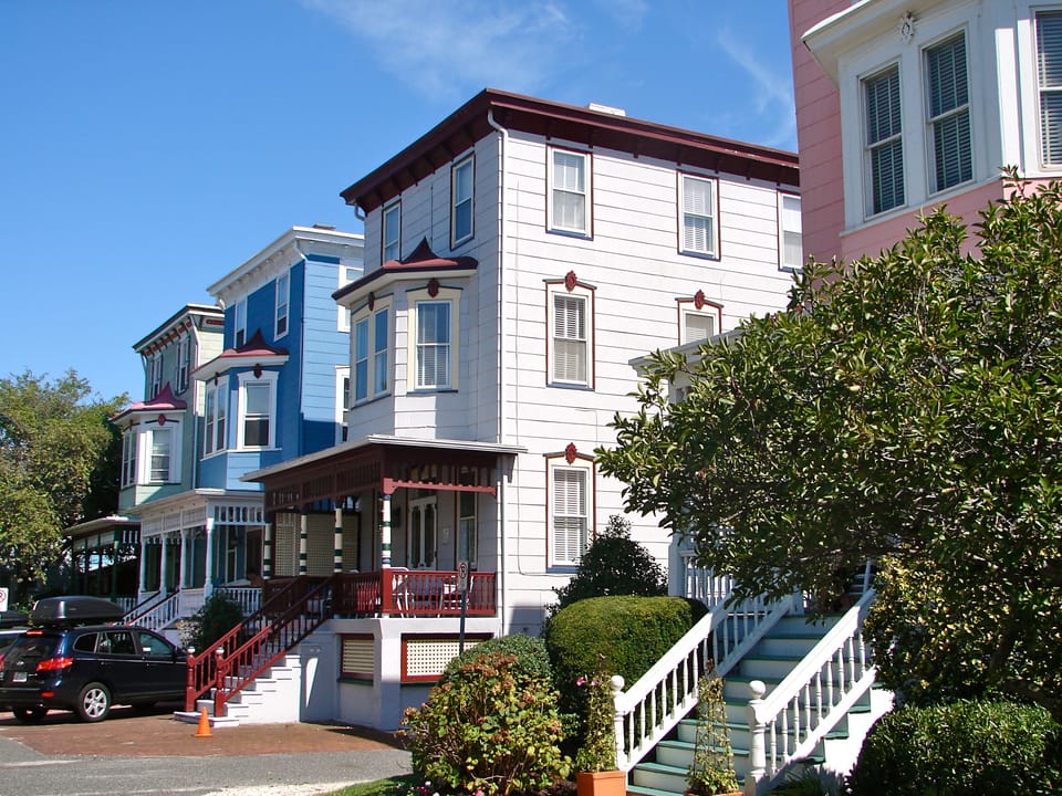 4 of the Atlantic Terrace Houses on Jackson St. Built 1891-92.	Architect Stephen Decatur Button. 7 essentially identical balloon frame houses built on the site of the Atlantic Hotel. Three stories in height, with a one story porch and a bay window with an ogee roof at the second story. This shows th