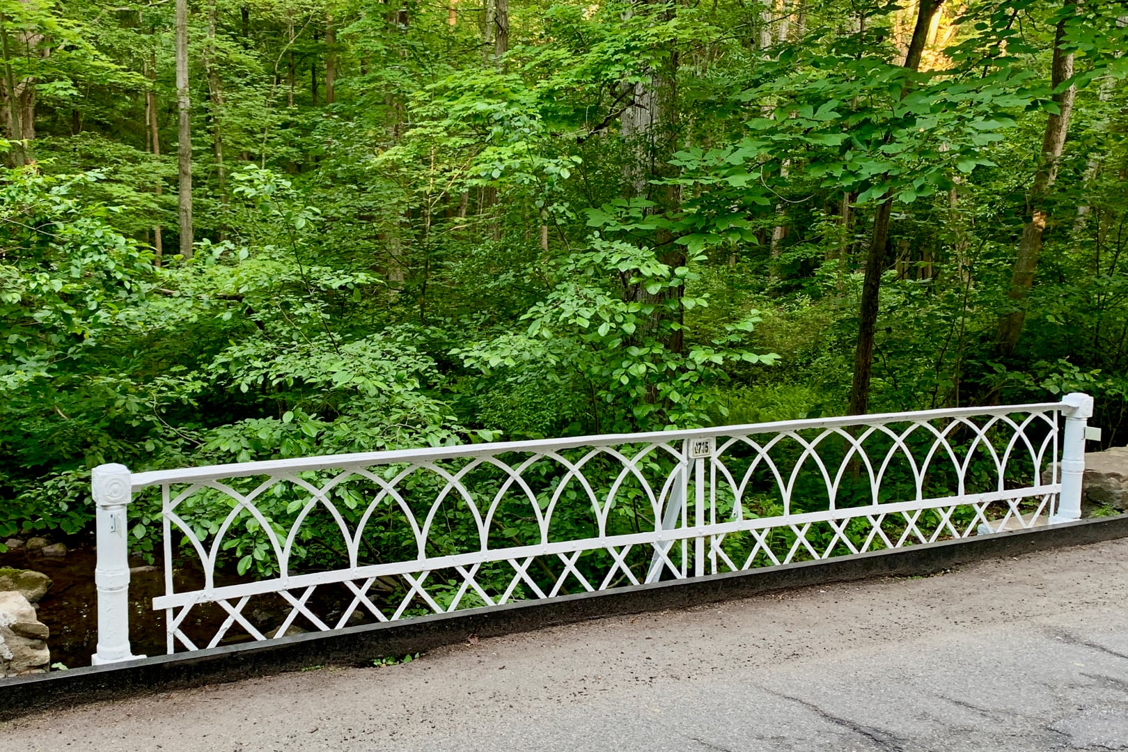 Gothic-arched railing of the circa-1901 Combs Hollow Road bridge over India Brook in the Combs Hollow Historic District, Morris County, New Jersey
