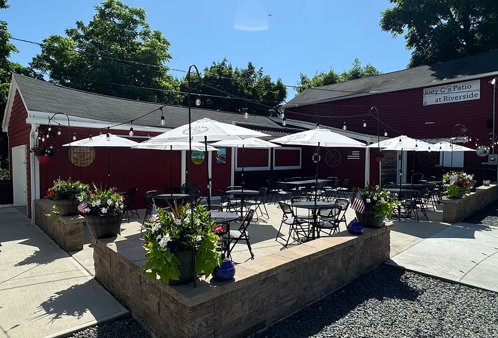 Outdoor patio and red-painted exterior of the Riverside Inn at 102 Woodfern Road, Neshanic Station, New Jersey, a 19th-century tavern building