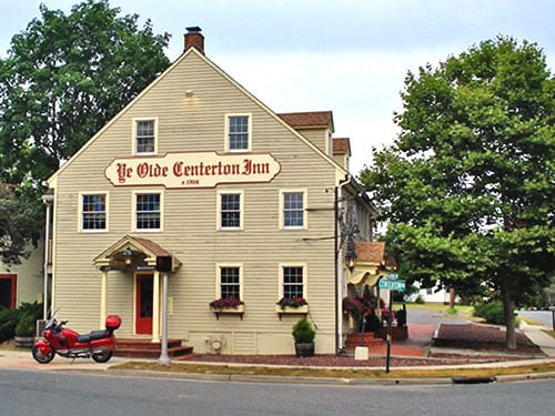 Three-story yellow clapboard colonial Ye Olde Centerton Inn at its crossroads site in Pittsgrove, New Jersey, operating since 1706
