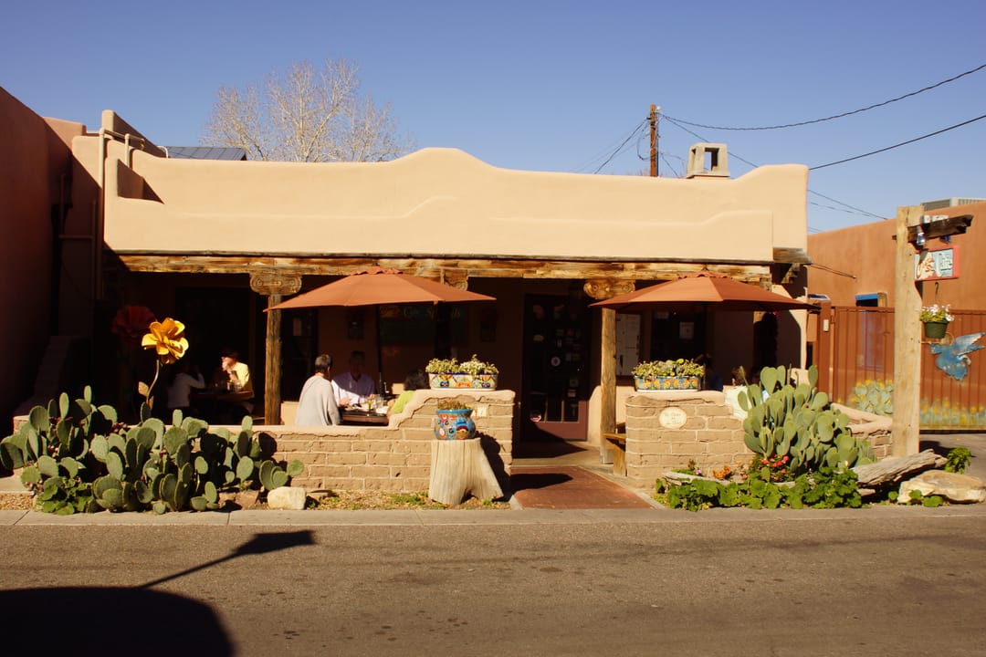 The portal and patio entrance of Church Street Cafe (Casa de Ruiz), with diners seated at outdoor tables, Old Town Albuquerque, 2013.