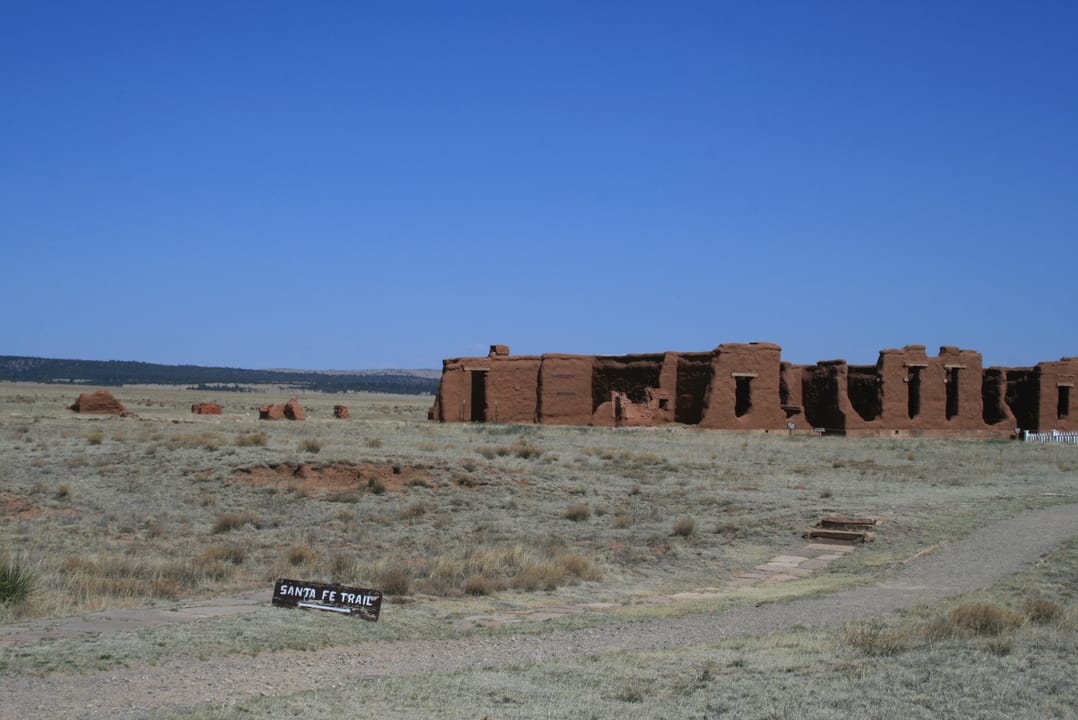 Adobe ruins of the third Fort Union, with wagon wheels and cut-stone foundation remains in the foreground, Fort Union National Monument, New Mexico.