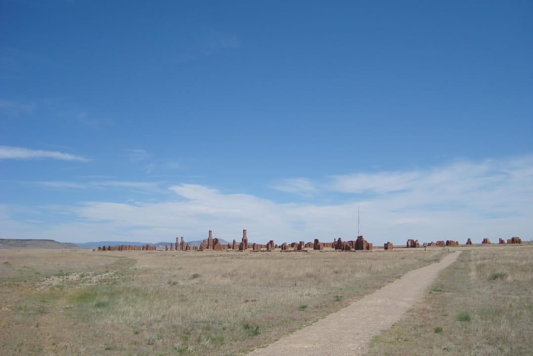 Wide landscape view of Fort Union's ruin field and the walking path across the prairie, Fort Union National Monument, New Mexico.