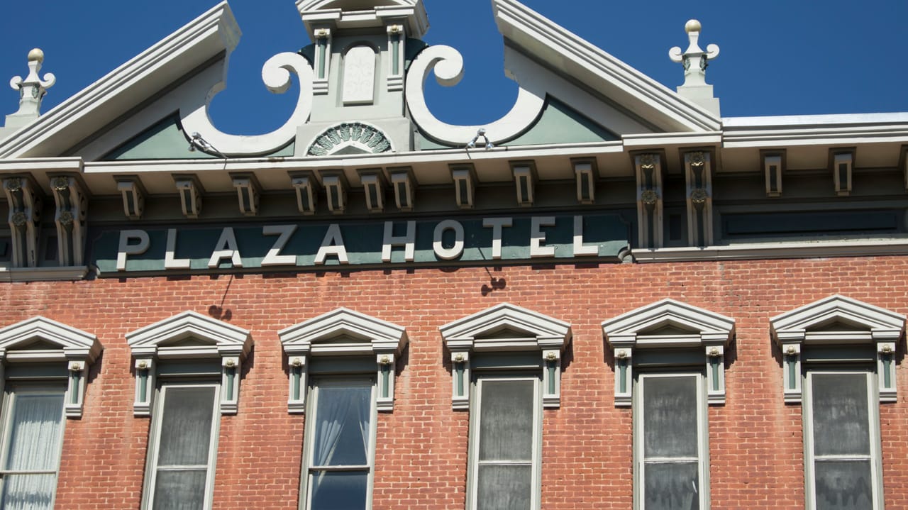 Detail of the Plaza Hotel's pediment and painted PLAZA HOTEL sign above the third-floor windows, Las Vegas, New Mexico, September 2012.