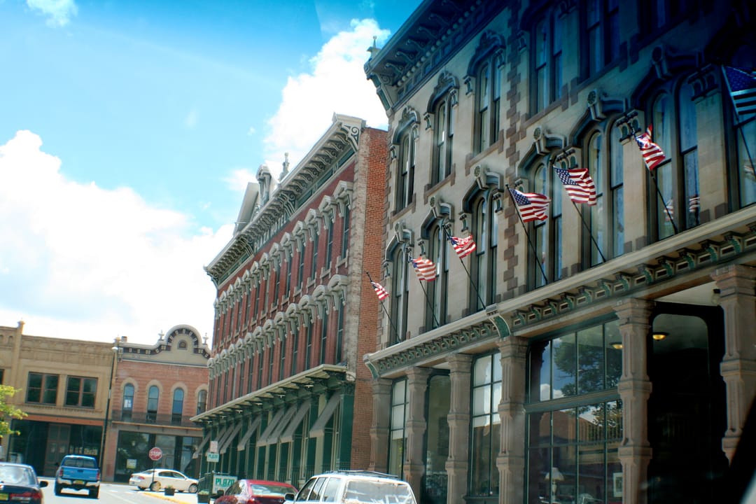 The Plaza Hotel's street-level arcade decorated with American flags, Las Vegas, New Mexico.