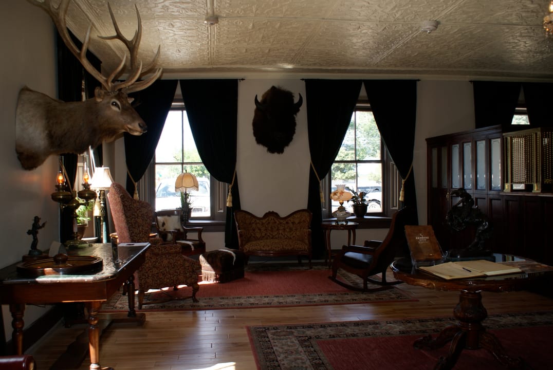 The St. James Hotel's public parlor/sitting room, period furnishings and a mounted deer head, Cimarron, NM.