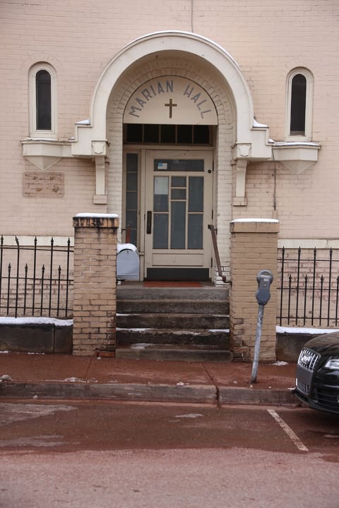 The arched entrance of Marian Hall, with "MARIAN HALL" carved above the door, Santa Fe.