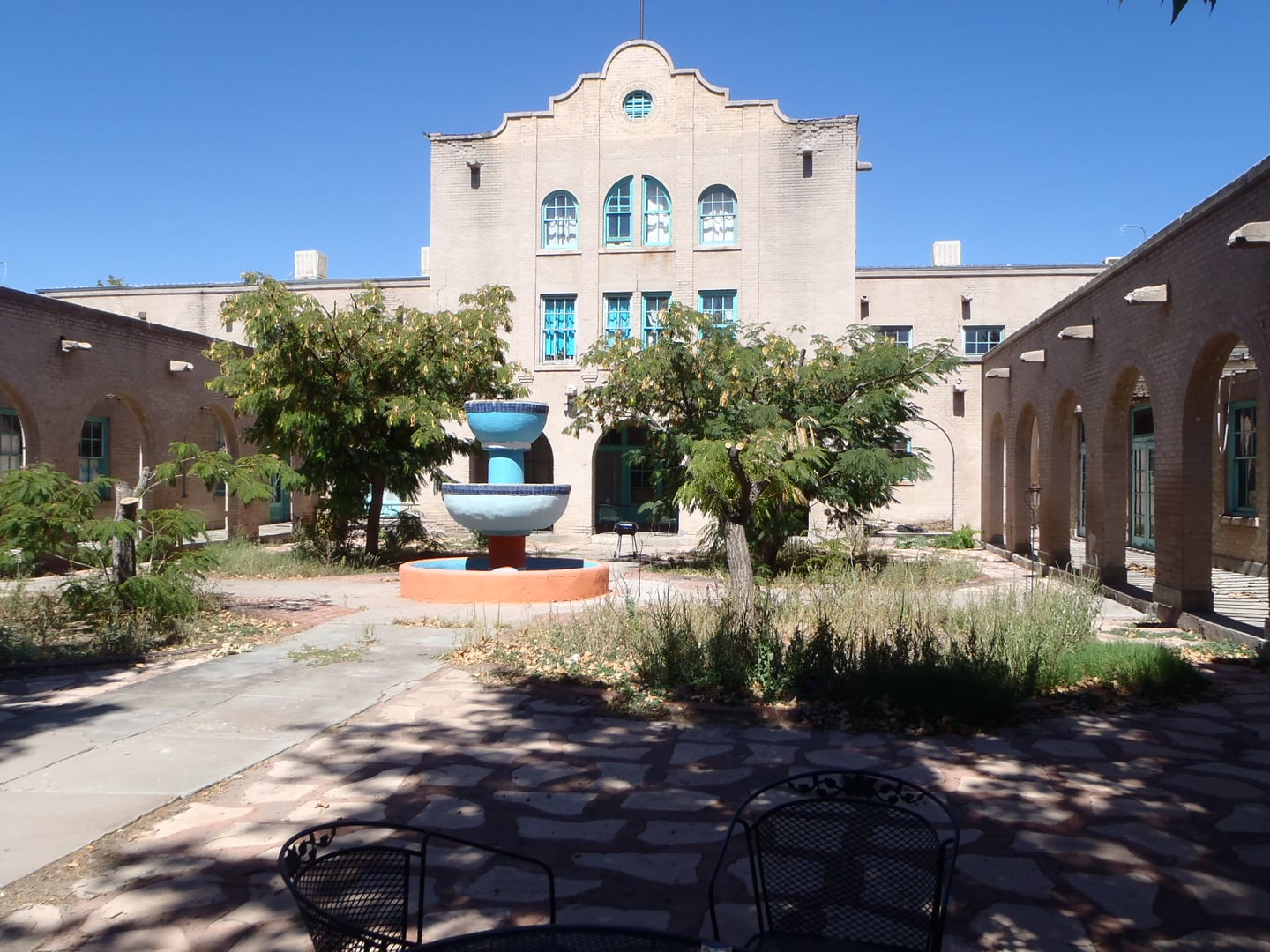 The 1919 Mission Revival Val Verde Hotel of yellow concrete brick in Socorro, New Mexico