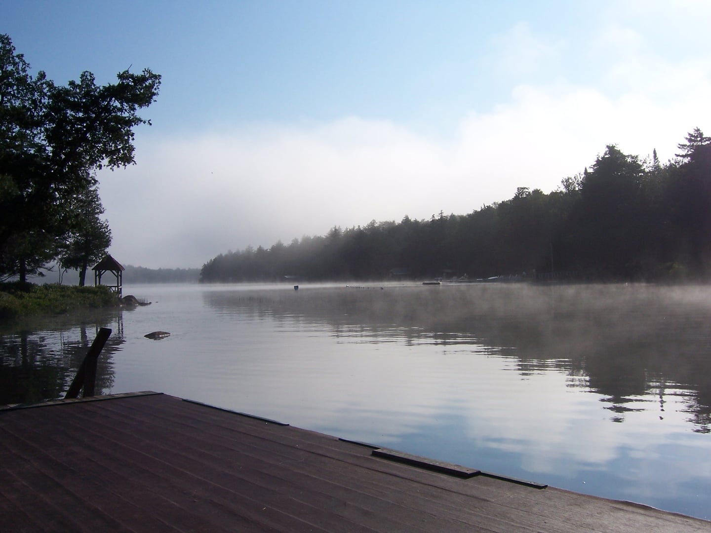 Big Moose Lake in the Adirondacks of Herkimer County New York with reflective water and tree-lined shore