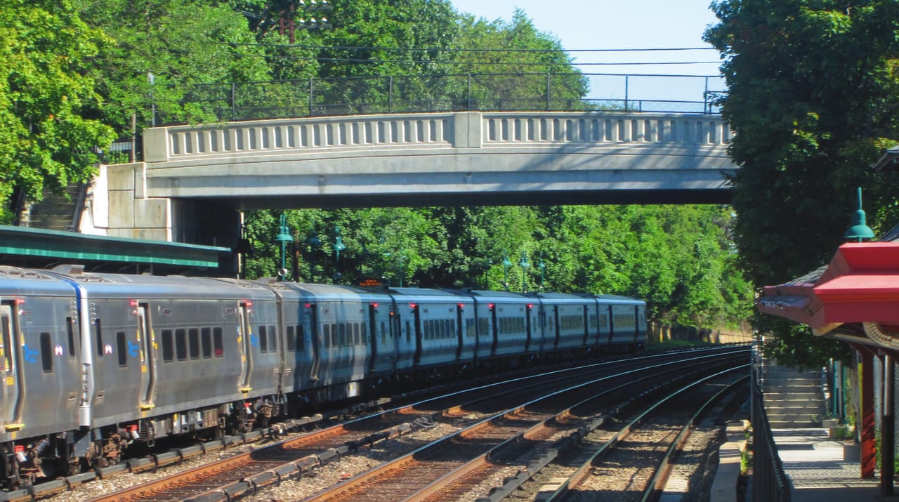 The Patrolman George E. Duggan Memorial Bridge in Irvington, New York carries North Buckhout Street over the Metro-North Hudson Line to River Road, just north of the Irvington (Metro-North station). Part of the station's northbound platform can be seen on the right.