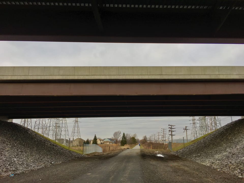 Passing under the Interstate 290 overpass along the Tonawanda Rail Trail, Tonawanda, New York, 15th January 2020.
